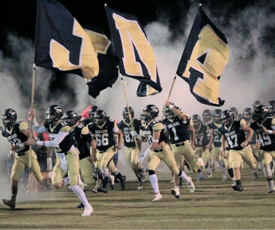 JMA football players run onto the field