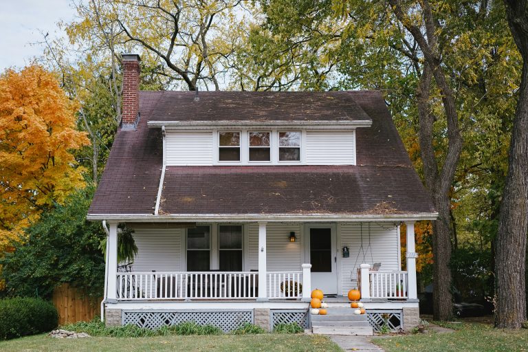 A white two-story home with a nice yard photographed by Phil Hearing.